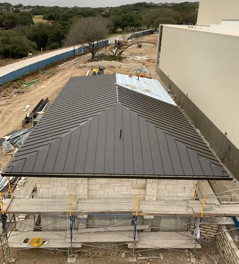 Metal roof new construction with scaffolding in Jackson